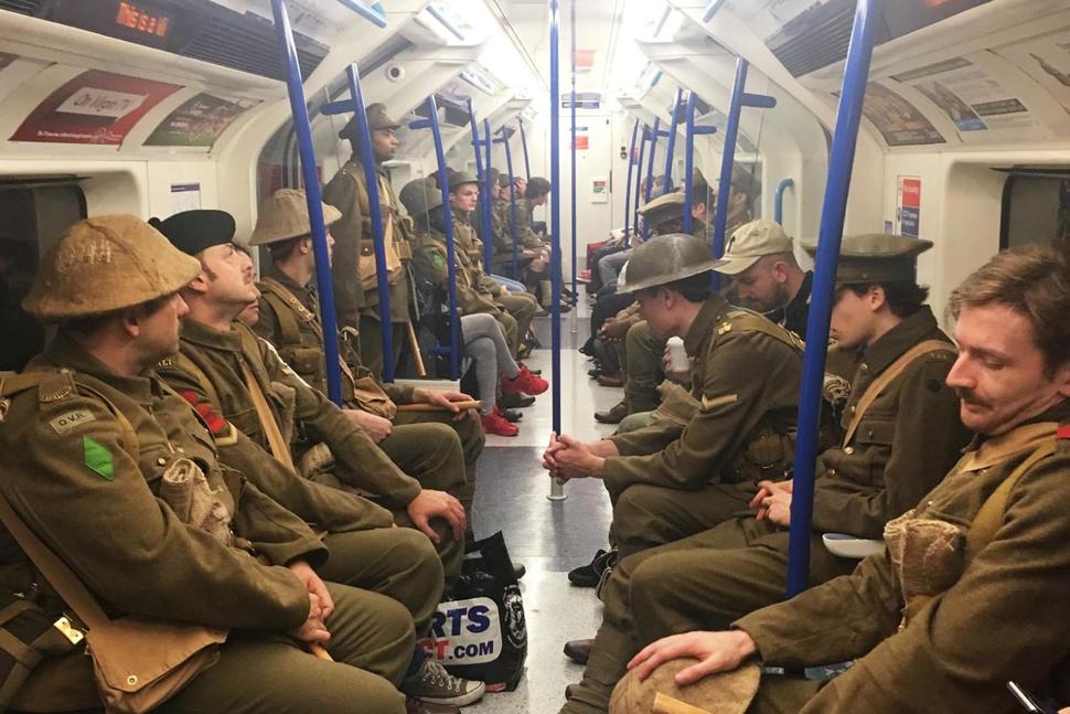 Men dressed as First World War soldiers mingle with regular commuters aboard an underground tube train in London, to mark 100-years since the start of the Battle of the Somme, early Friday July 1, 2016. London commuters were met by the eerie sight of people dressed as World War I soldiers as they made their way to work Friday, with the soldiers singing wartime songs or remaining silent, revealed later Friday as a Somme tribute, the work of Turner Prize-winning artist Jeremy Deller, National Theatre Director Rufus Norris and thousands of volunteers. (Sarah Perry / PA via AP) The Associated Press