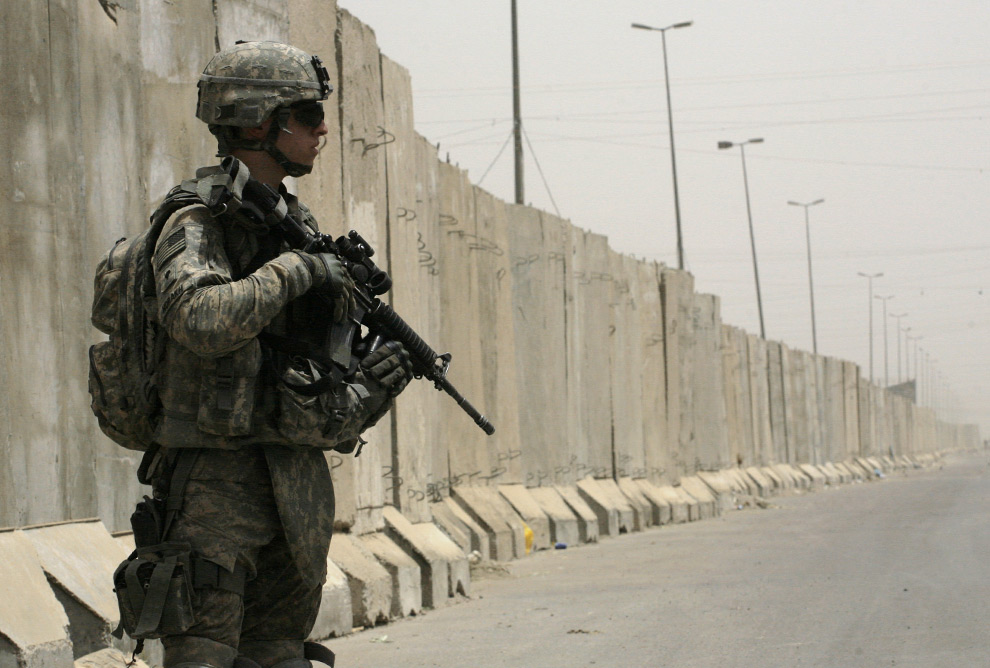 A U.S. Soldier of 1-6 battalion, 2nd brigade, 1st Army Division, patrols near the wall in the Shiite enclave of Sadr city, Baghdad, Iraq, on Monday, June 9, 2008. The 12-foot concrete barrier is has been built along a main street dividing southern Sadr city from north and it is about 5 kilometers, (3.1 miles) long. (AP Photo/Petros Giannakouris)